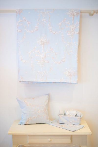 Pale blue floral bedspread and cushions